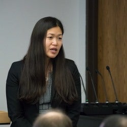 Jane Kim giving presentation at podium.