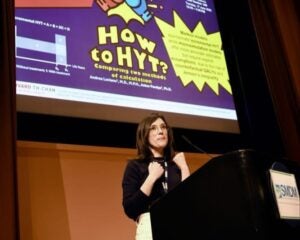 Andrea Luviano presents at podium