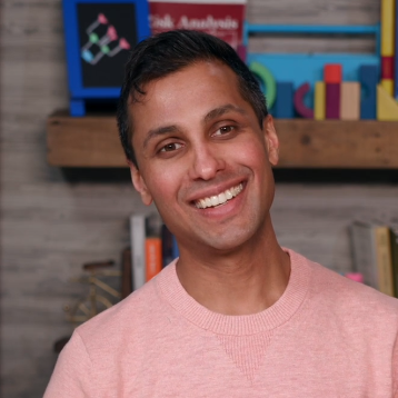 Ankur Pandya smiling offcamera while seated at desk