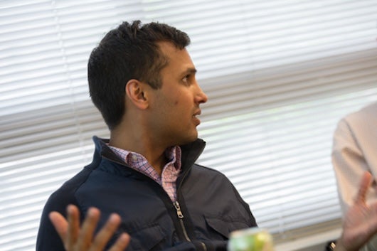 Ankur Pandya speaking, looking to one side, during meeting.