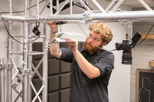 Image of Jake Waxman Assembling Technical Equipment in Media Hub.