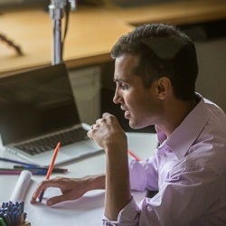 Ankur Pandya working at GHELI studio desk.