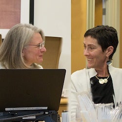 Eve Wittenberg and Lisa Prosser looking at each other, smiling, and in conversation.