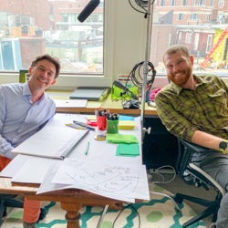 Photo of Stéphane and Jake smiling for camera while storyboarding